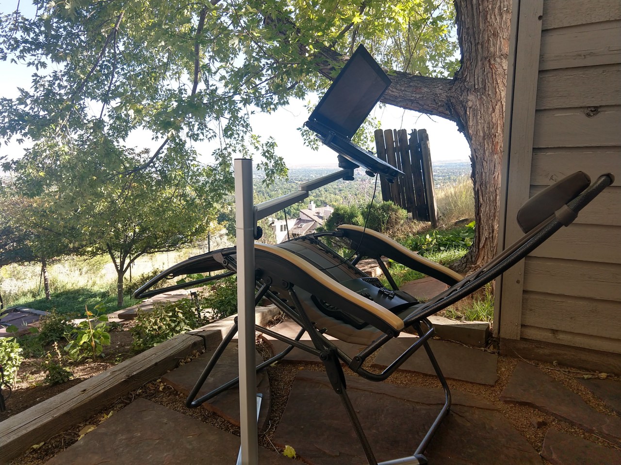 reclining setup on patio under tree