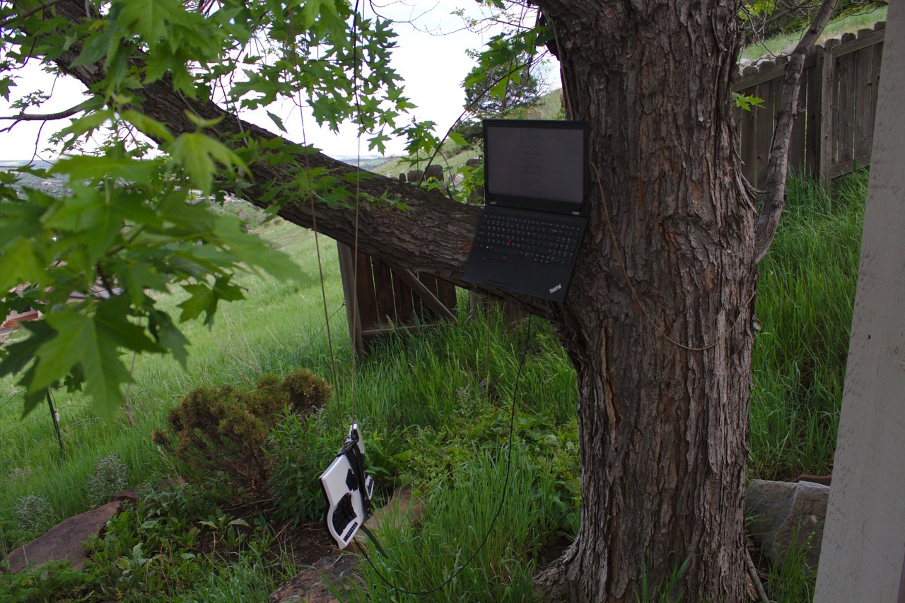 photo of a kinesis advantage keyboard suspended from tree