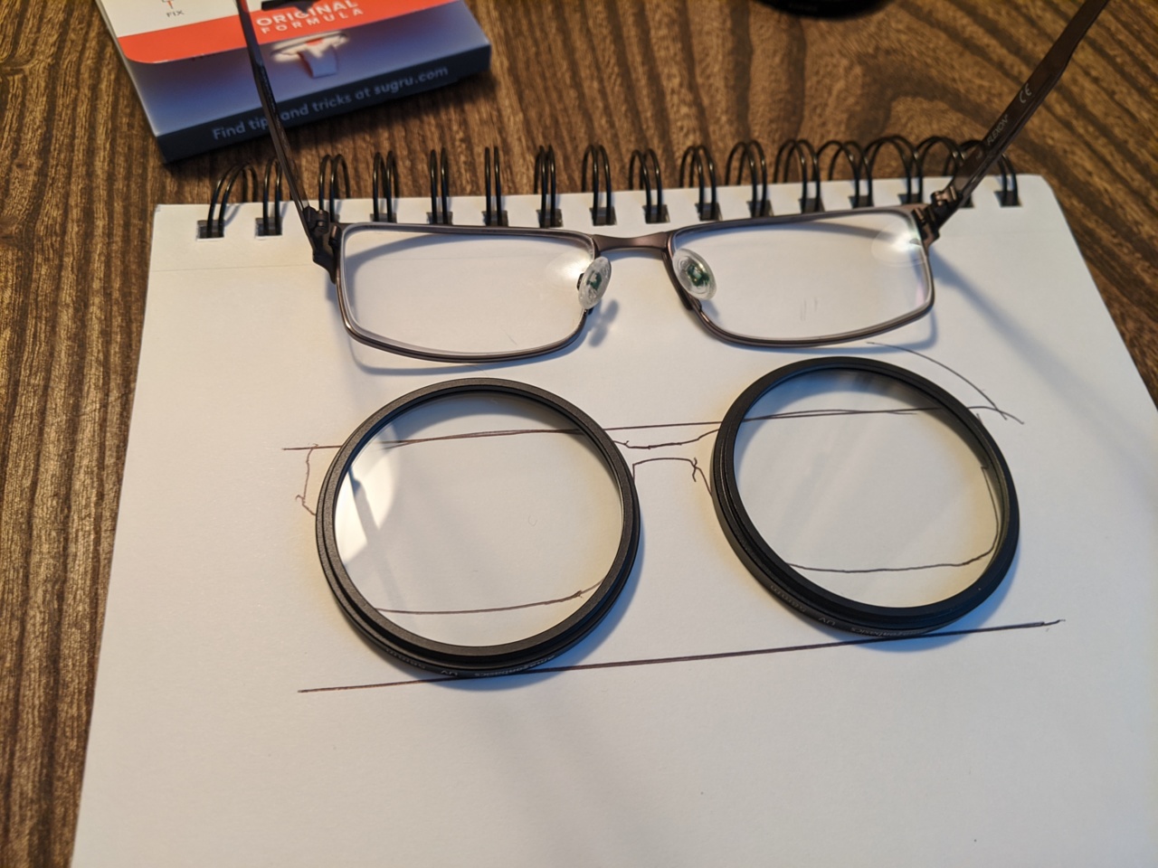 eyeglasses next to tracing overlaid with UV filters
