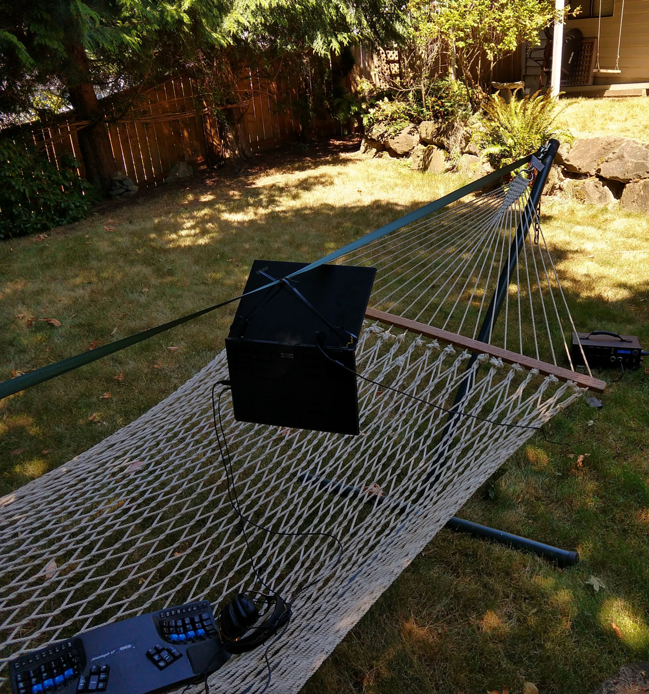 strap tensioned across hammock stand